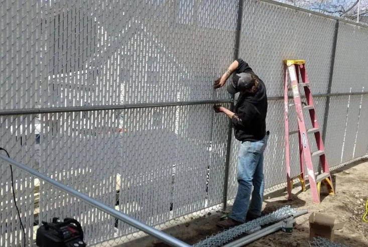 worker doing an emergency fence repair